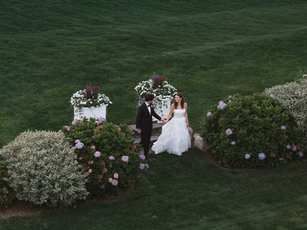 Aerial view of a couple among the hydrangeas on the Inn’s lawn