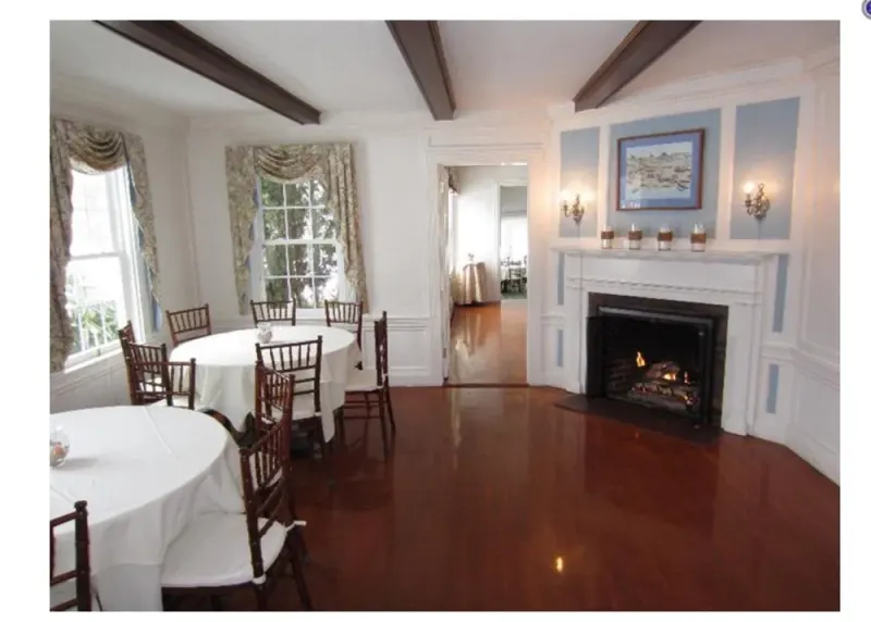 Dining room with fireplace set with round tables