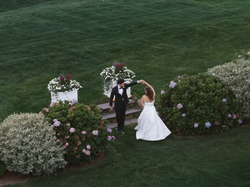 Bride and groom walking the garden path at the Inn