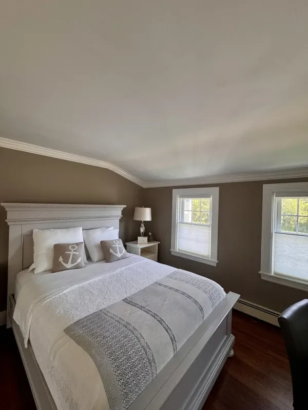 Bridal suite bedroom with a white bed and anchor pillow